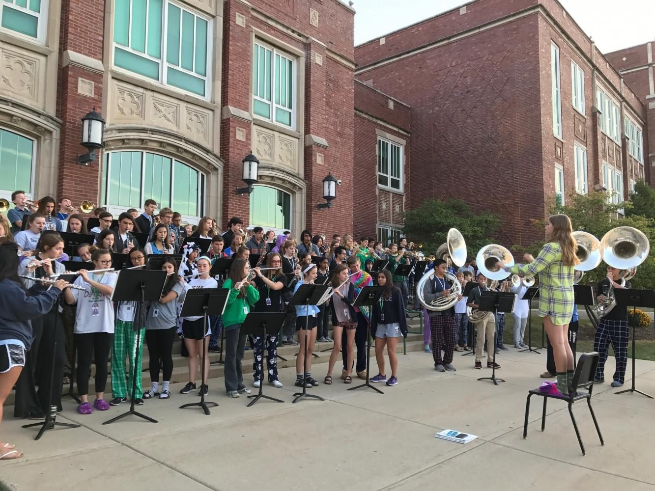 York marching band wears their pjs as they play in front of the main entrance to welcome students to school.  