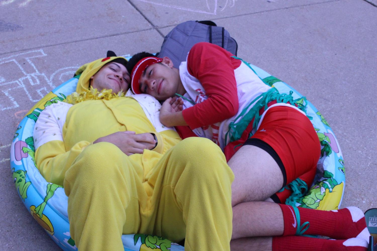 Seniors Matt Schlitter (left) and Alexian Nevarez (right) cuddle up before school while embracing the Hawaiian theme.