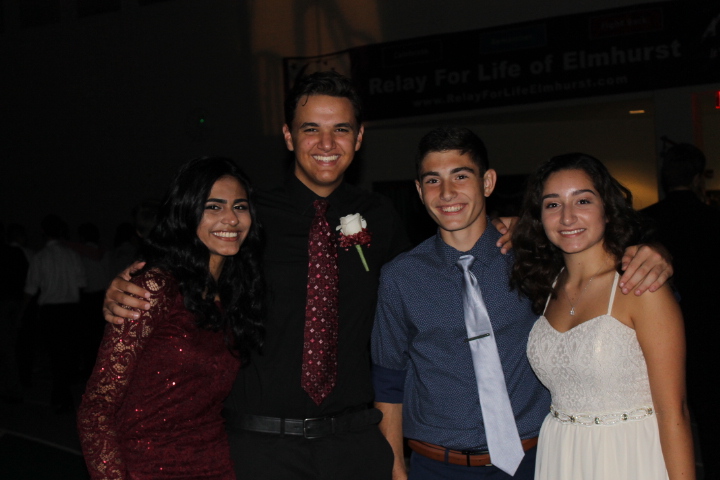 From left to right, sophomores Nida Ahmed, Anthony Agular, Paolo Favuzzi, and Lily Lopez smile while entering the dance as a group on Sat., Sept. 23, 2017.