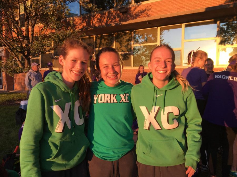 Lydia Hickey(left),  Maggie Clink (middle), and Emma Kern(right) come together to celebrate their successful run at the Western Suburban Silver Conference Division Meet at Lyons Township.