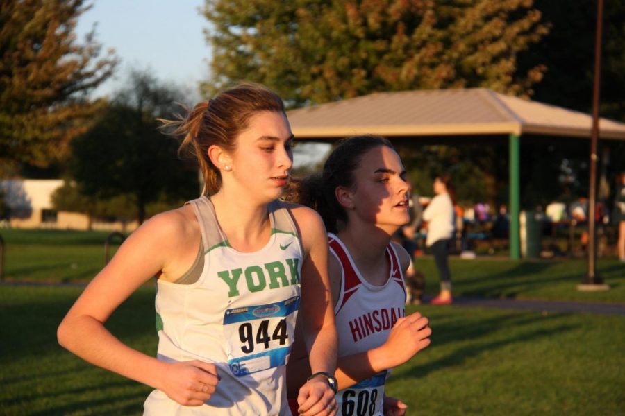 Senior Lily Kilgast, fiercely fighting for the first place finish in the Junior Varsity race at the Western Suburban Silver Conference Division Meet that took place on Wed., Oct. 18 2017. 