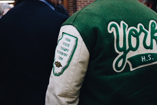 York alum honors York cross country and shows off his 1990 state champion patch on his letter-man jacket. Jan 27.