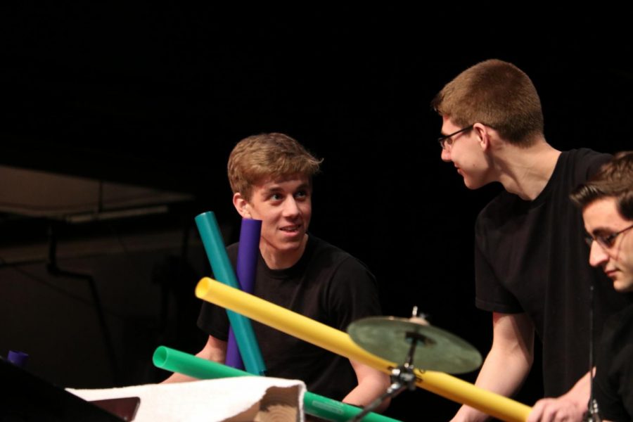Senior Corey Elliott (left) and senior Eric Doberstein (right) give each other optimistic glances before their part in their Boom Whacker performance in the percussion concert. 