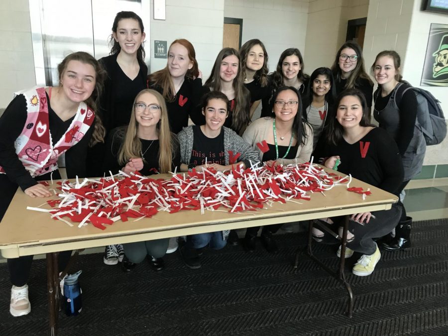 Members of EMPOWER show off the red Vs they produced for V-Day and wear black in support of #MeToo. 
