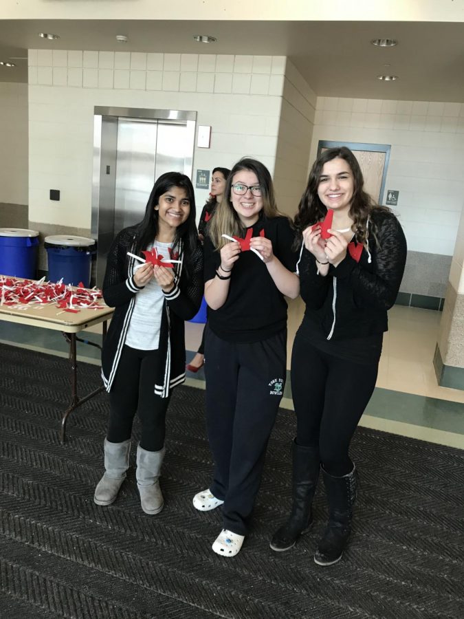 Sophomores Sakeena Broachwala, Khloe Lesus, and Mikaela Jopes help pass out Vs to their fellow peers on V-Day.