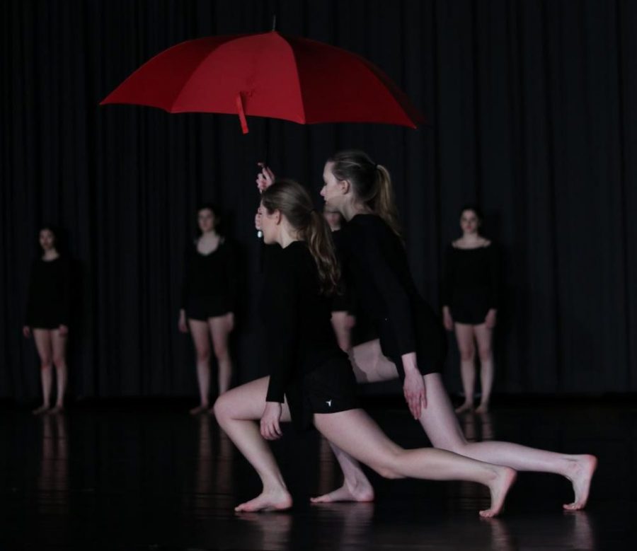 Two members from Advanced Dance use a red umbrella as their main prop for their interpretation of senior Nate Swansons photo.