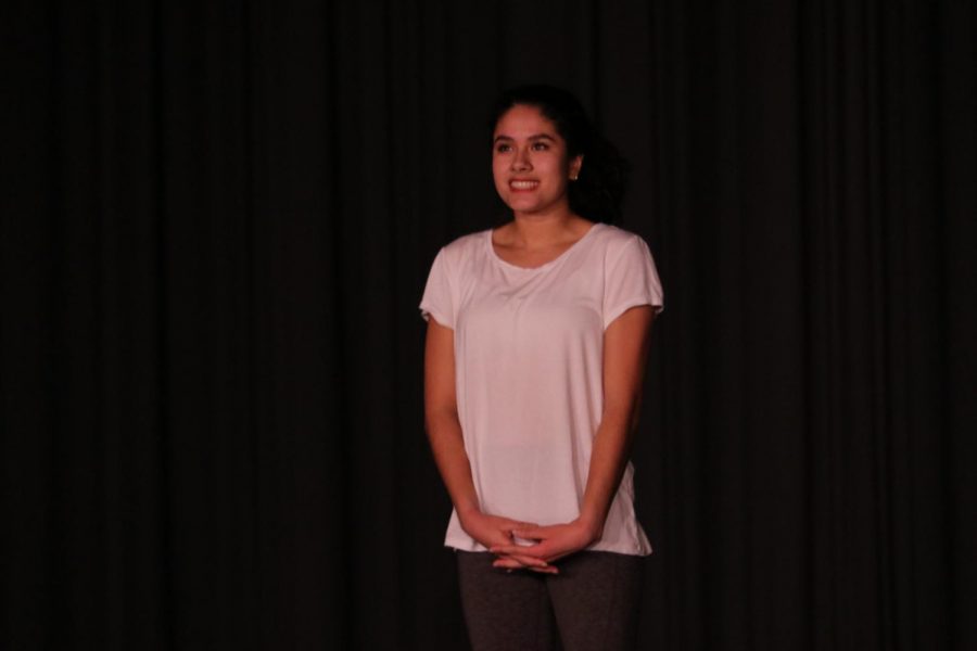 Valdez presenting her piece prior to their performance.