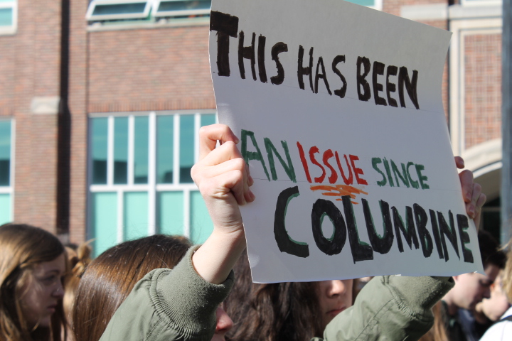 Sophomore Maggie Wisnewski holds a sign exhibiting the length of this issue, with the first large, widely known school shooting was Columbine Masacre in 1999, almost twenty years ago.