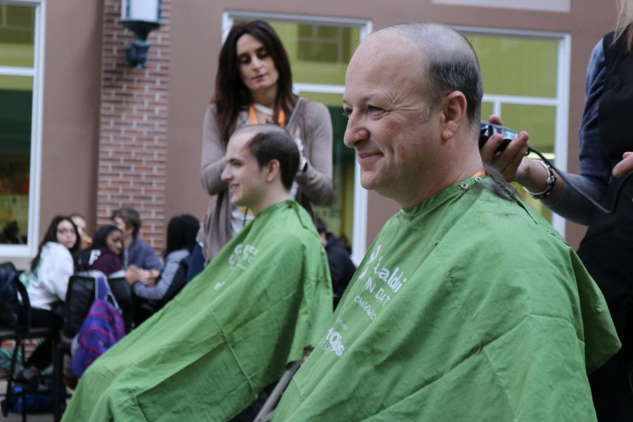 Steven Strauss, father of senior Carter Straus, gives a grin of confidence as his head is shaved for the St. Baldricks Foundation. He raised $3,920. Friday, Mar. 16, 2018