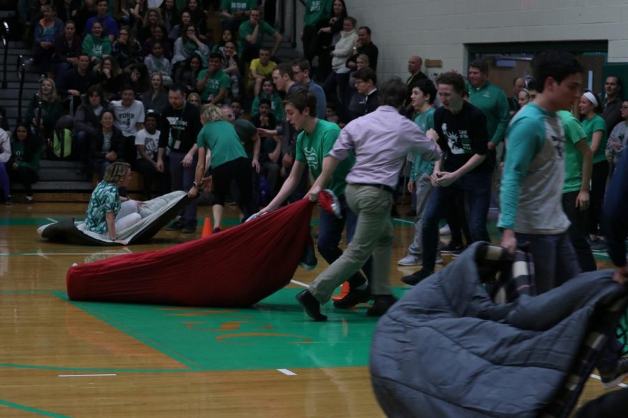 Teams compete during the sleeping bag chariot race. 