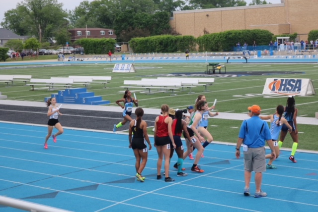 Junior Sarah Pinkowski prepares to receive the baton from sophomore Marissa Chavez in the 4X400m relay. May 18.2018.