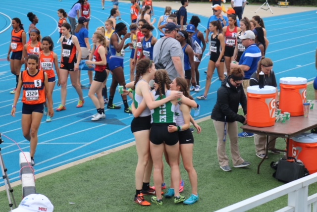 The 4X400m relay, Sarah Pinkowski, Sydney Malaga, Bella Walker, and Marissa Chavez embrace at the finish line.