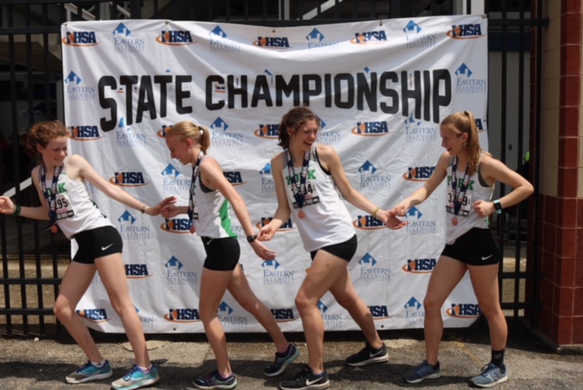 The all-state 4X8 team (From left to right) Lydia Hickey, Emma Kern, Katherine Tomaska, and Sarah May recreate their 4X8 handoffs while sporting their all-state medals.