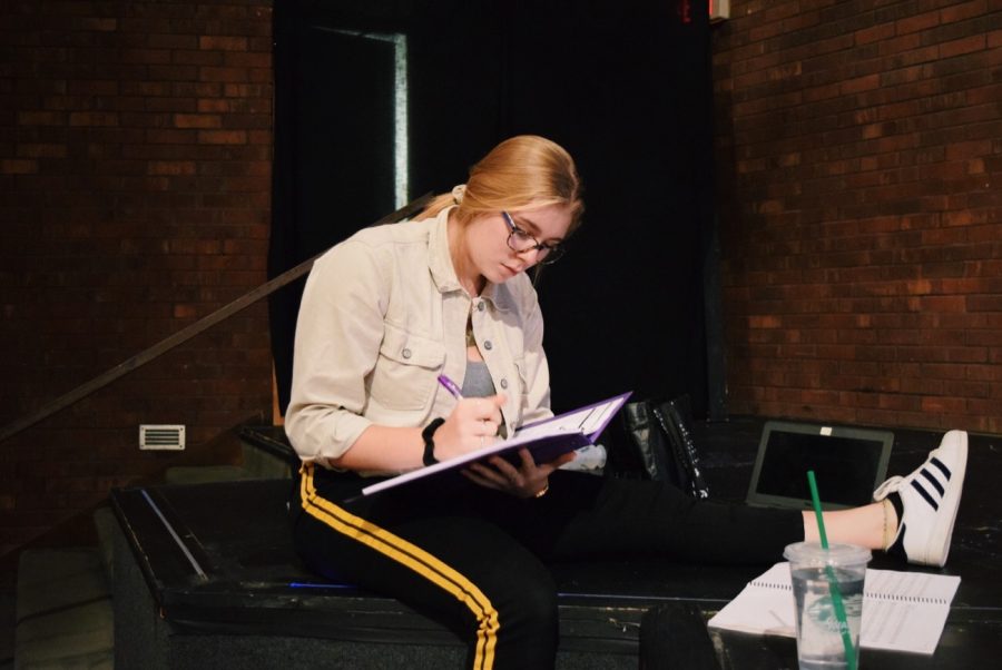 Head stage manager Evie Nudera organizes her thoughts in her script.