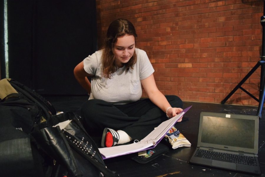 Assistant stage manager Johanna Kramer prepares for upcoming rehearsals and studies her script.