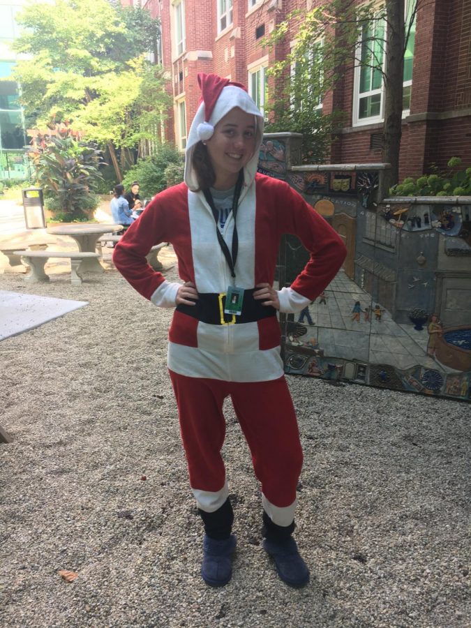 Senior Claire Libert dresses like its December in her Santa Claus onesie. Photo by Isabelle Downey 