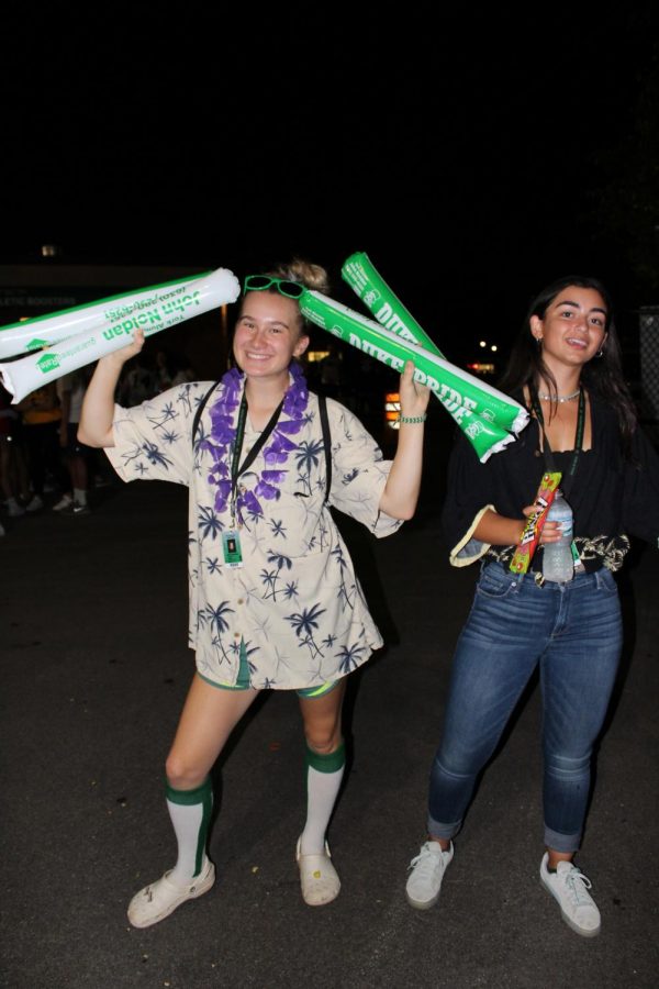 Seniors __ and Isabelle Niccoli show off their noisemakers. 