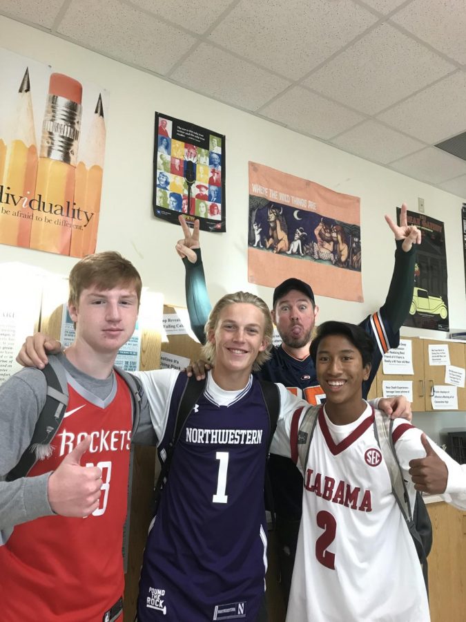 Juniors (from left to right) Sam Grabau, Jake Hansmann, and Roshan Hoffman join with assistant principle Ryan Doherty for Jersey Thrusday.