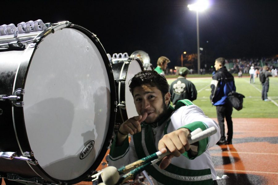 Senior marching band member, Nate Arzet, gets excited to perform at one of his last home games at York. 