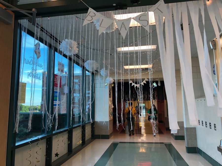 The second part of the Empower hallway is covered in white streamers and decor symbolizing the present day of women  empowerment 