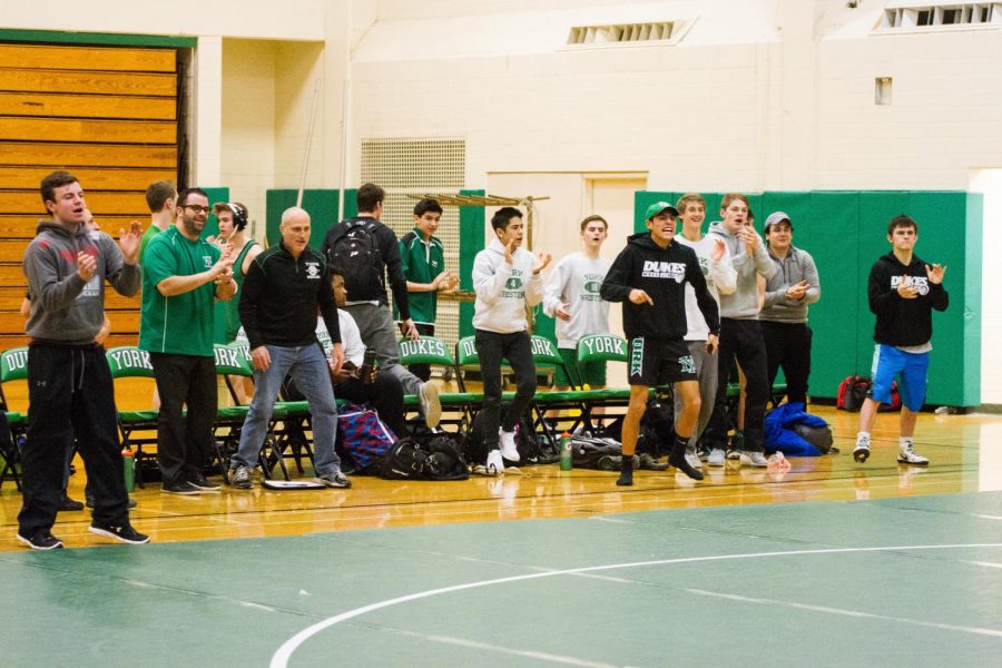 Members of all levels get on their feet to guide a fellow wrestler towards a win. 