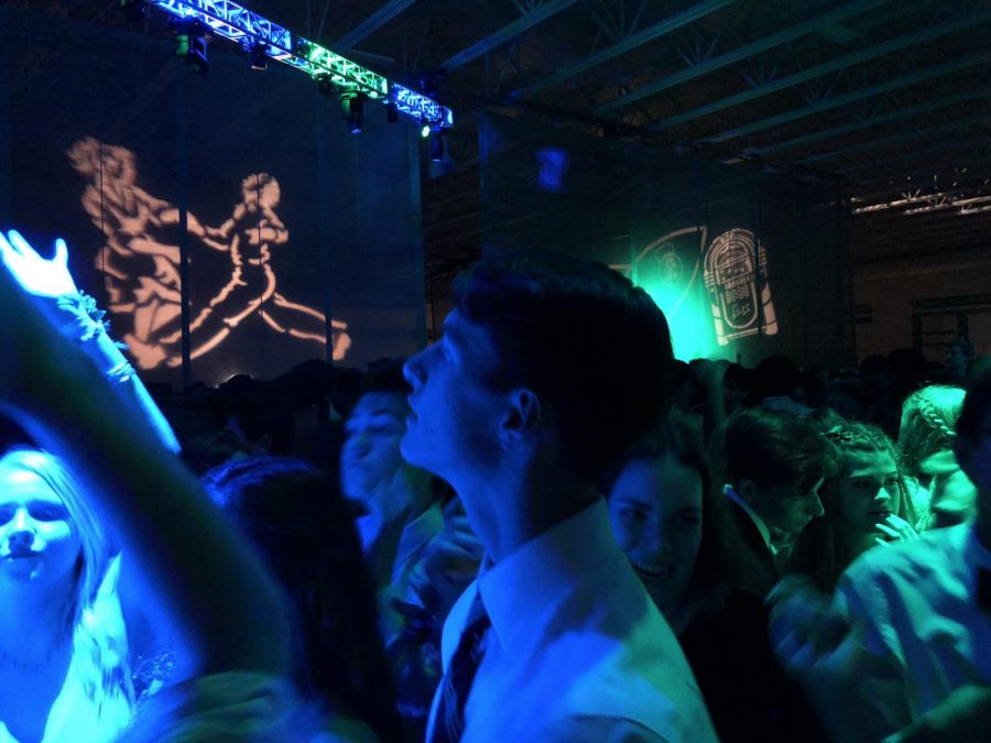 Senior Matt Hauser looks around at the field house, which was transformed into a dance floor for the students at the annual Homecoming dance in 2018.