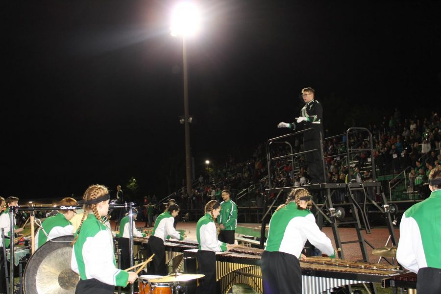 Senior drum major Jack Rosenberg conducts the marching band through their performance during the halftime show. 