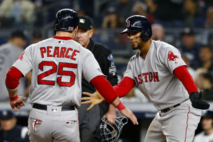 Red Sox first baseman Steven Pearce celebrates scoring a run with teammate Xander Bogaerts.
