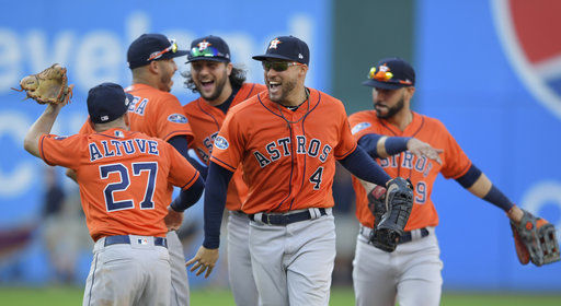 The reigning champion Houston Astros celebrate a victory over the Cleveland Indians.