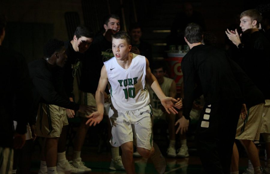 Junior Nate Shockey runs onto the court after his name is announced. Photo courtesy of SR Photo