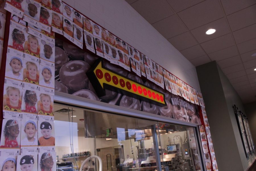 The walls of Krispy Kreme can be seen covered with pictures of each patient helped by the St. Judes Hospital fundraiser. 