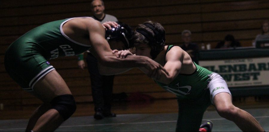 Jason Lewis snaps opponent down in preparation for a varsity pin against Glenbard West. 