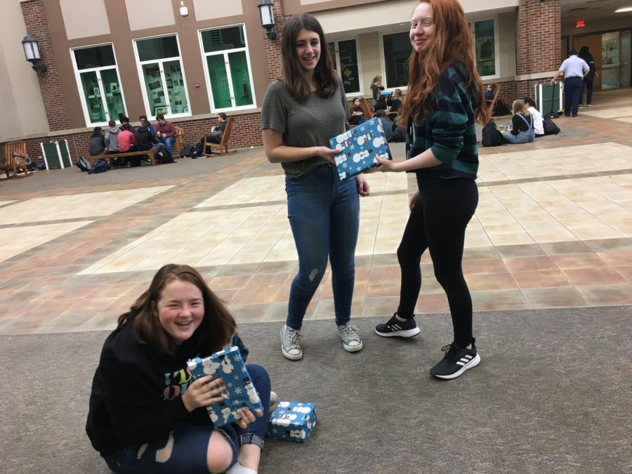 Ellie Bodach, Emily Carrasco, and Ciara Belfiore are giving each other presents for the holiday season in the lunchroom. All three of the girls don’t seem to be stress at all and have jolly smiles on their faces. Dec. 17, 2018.
