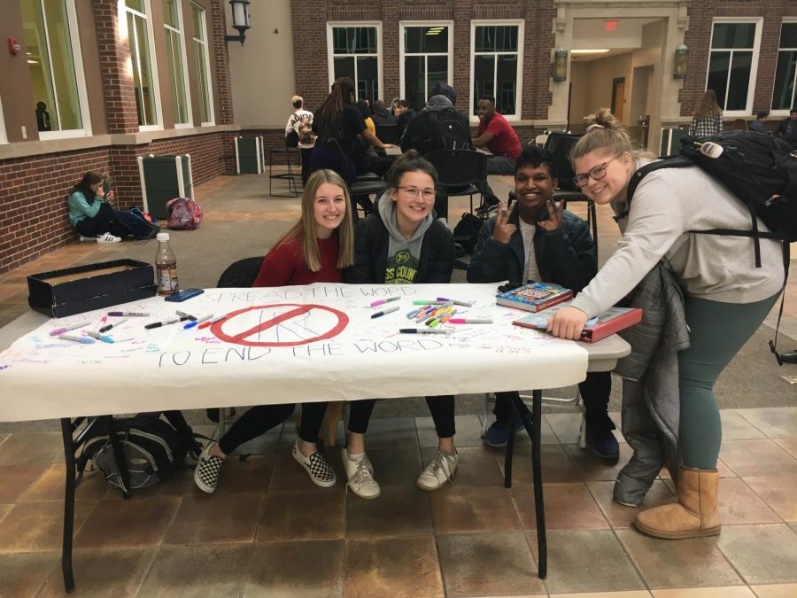 Students and Best Buddies board members (from left to right) senior Delani Kazmierczak, junior Maddy McGreal, senior Cyril Kappen, and Junior Ella Pittman encourge other students to take part in the campaign by signing the banner.