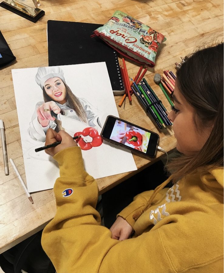 Senior Libby Wagner works on a colored pencil drawing in the AP art class.