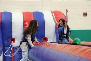 Seniors Anna Morley and Sarah Pinkowksi get pumped up to participate in the bungee run at the senior barbecue. May 17, 2019.