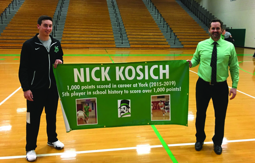 Nick Kosich receive banner for becoming, respectively, the 5th player to reach 1,000 career points in York history. Photo courtesy of York Athletics 
