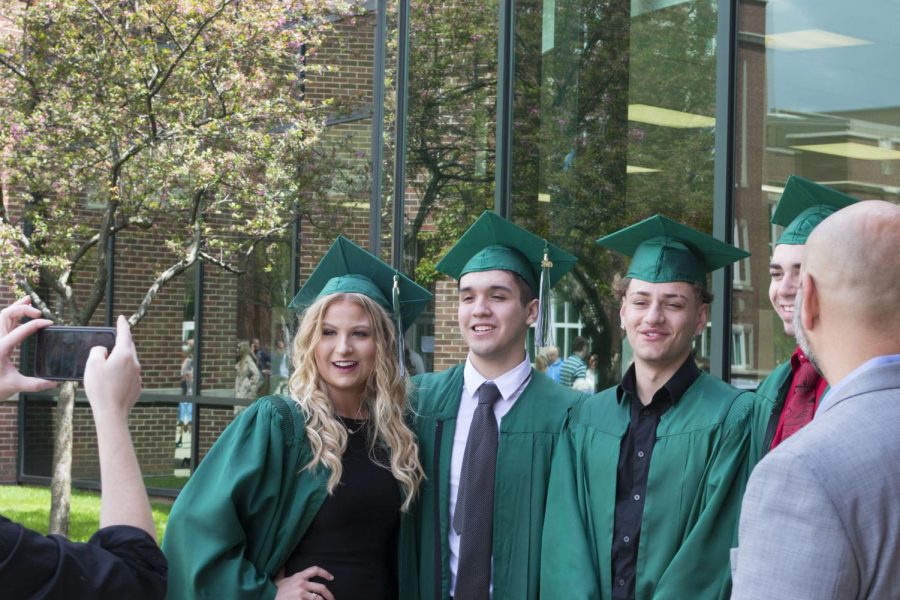 Graduates Haley Stefans, Stephen Rosario, and Alexander Karadimas snap a picture outside York minutes before the ceremony begins. May 19, 2019.

