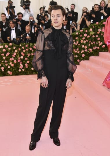 Harry Styles sports a half sheer Gucci top paired with black Gucci trousers at the MET Gala 2019.