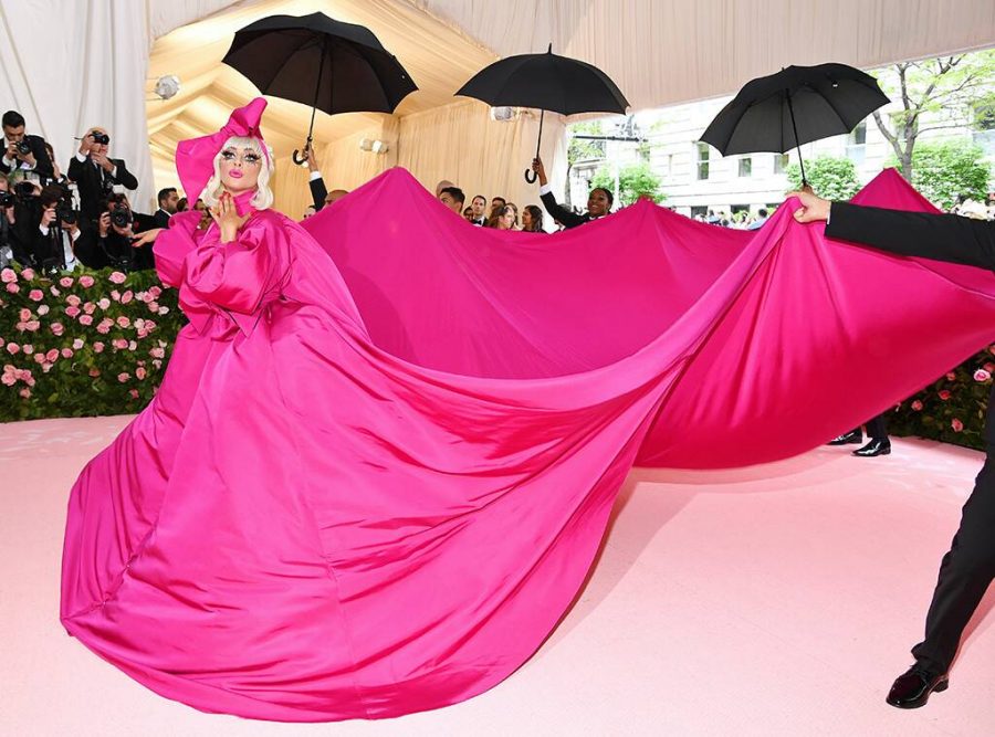 Lady Gaga turns heads in her enormous fuchsia gown and matching headband. Gaga went on to change her look three additional times throughout the night.