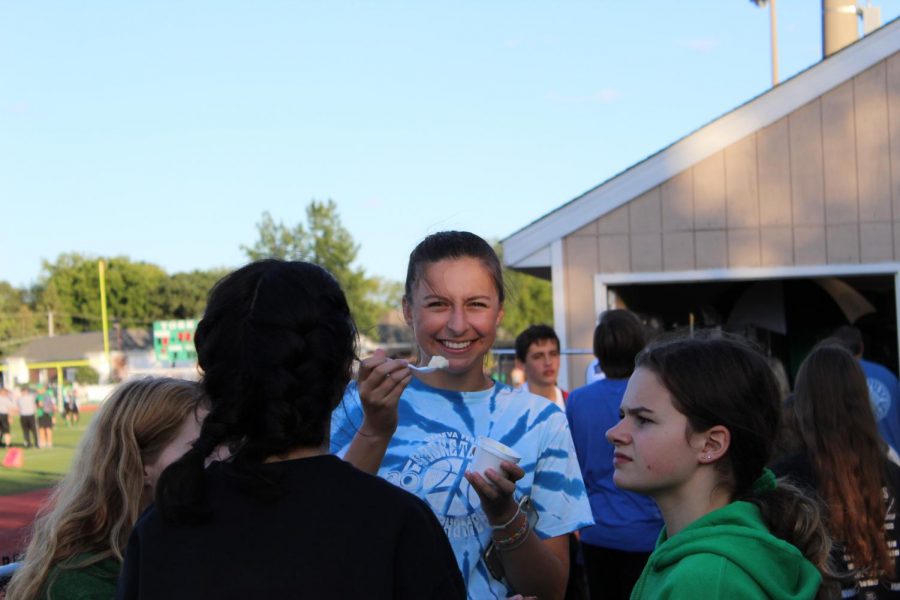 Maria Chornij, sophomore, smiles with her ice cream while talking with friends. 
