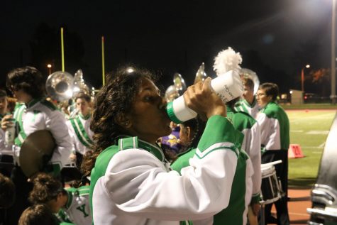 During a break between songs, junior Anjaly Kappen drinks out of one of the reusable water bottles provided for the entire marching band.
