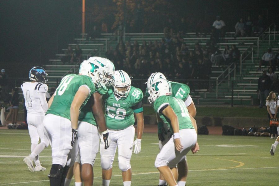 Junior quarterback Max Asaad (10) calls the play to his offensive line.