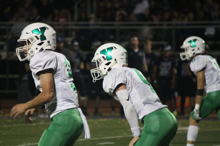 Junior quarterback Max Assaad (10) and senior running back Nick Conroy (4) lineup aside each other prior to the snap.