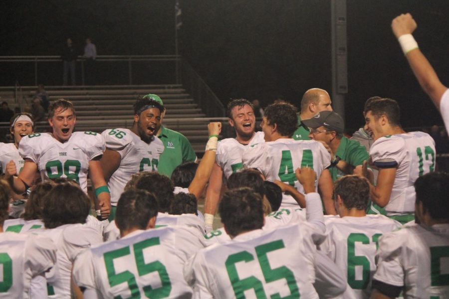 The team gets fired up in their post-game huddle prior to defeating Downers Grove North 28-26.