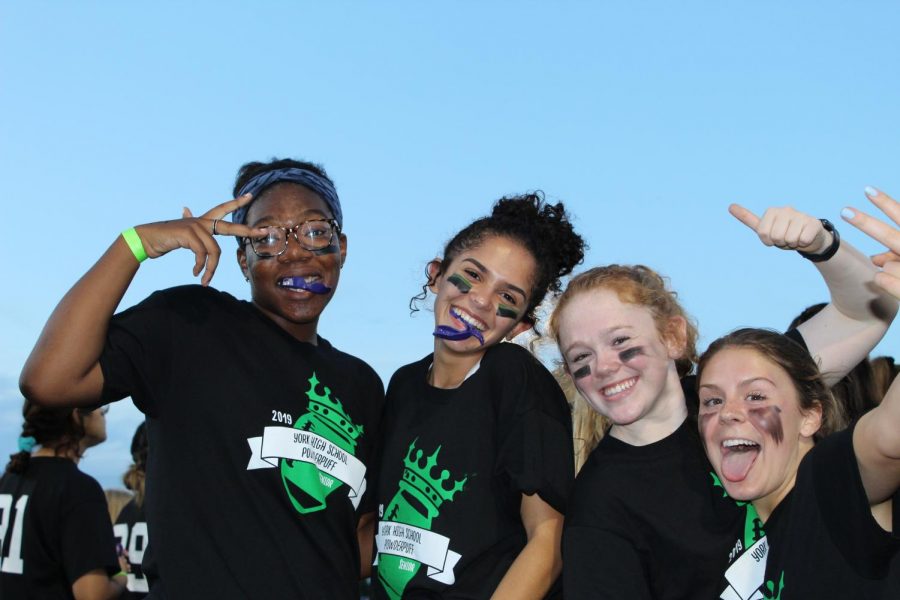 Seniors (left to right) Wendy Ofosu, Gigi Stechschulte, Elly Fitzgerald and Madison Justus have fun on the sidelines. 
