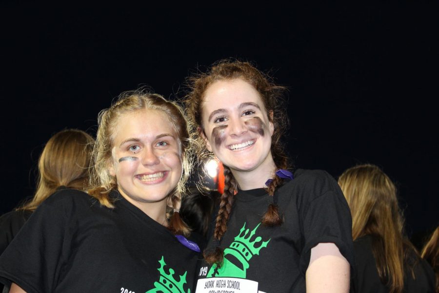 Seniors (from left) Murphy McFarlane and Grace Maietta pose for a picture on the sidelines. 