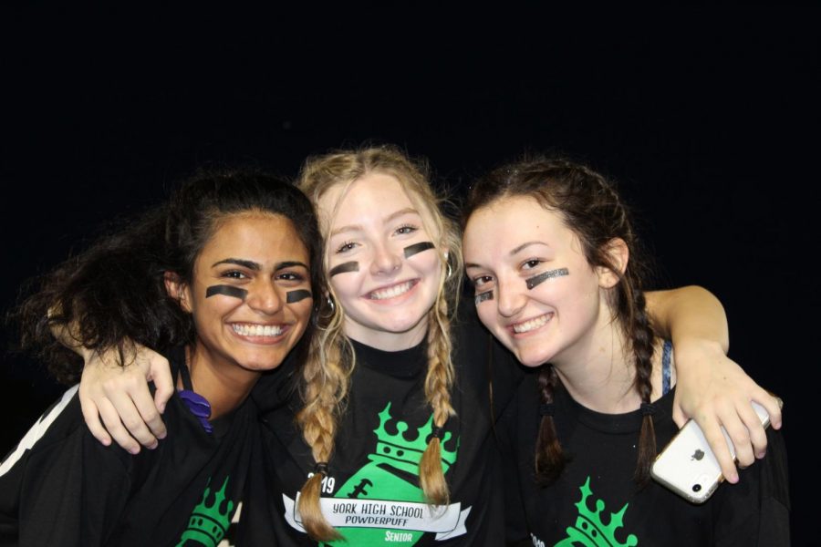 Seniors (from left) Nida Ahmed, Cece Spirakis and Erin Quaid pose for a picture on the sidelines. 