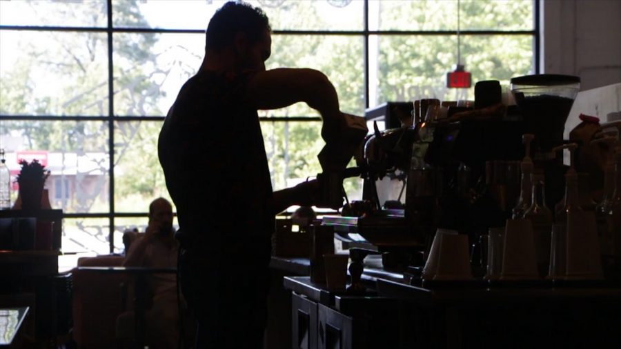Shift manager Alex Orsi brews a coffee at the Workshop and Roastery location in north Elmhurst.