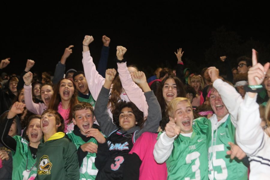 Freshman celebrate after the Dukes score a touchdown against Hinsdale Central.